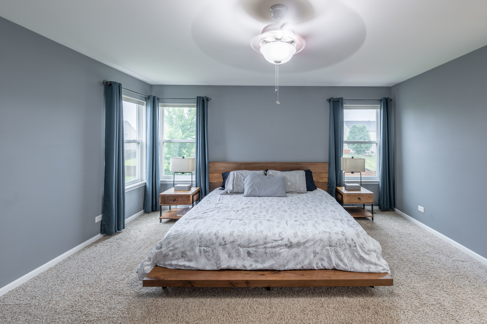 4333 Schofield Drive Oswego, IL 60543 - Photo 7 of 14 a bedroom with a large bed and a chandelier