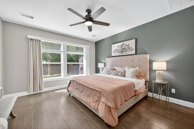a bedroom with a large bed and a large window