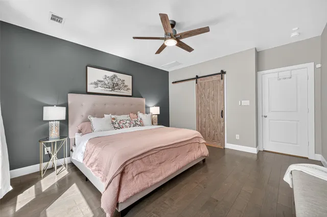 a bedroom with a bed and a painting on the wall
