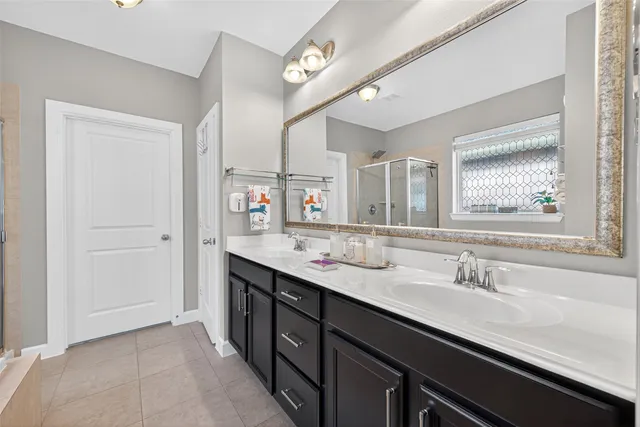 a bathroom with a double vanity sink a and a mirror
