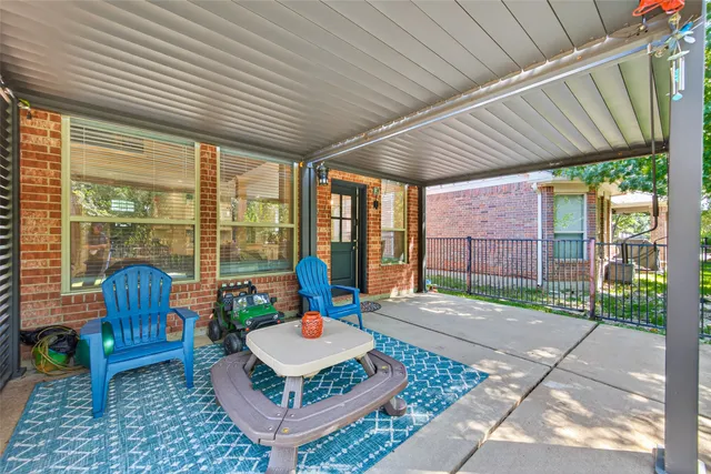 a view of a patio with a table chairs and a backyard