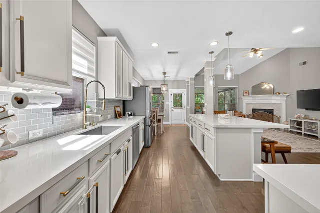 a large kitchen with stainless steel appliances lots of counter top space