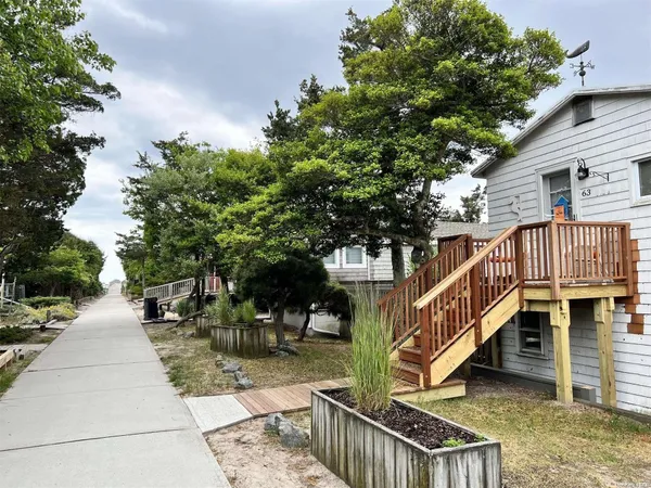 a view of street along with deck and trees