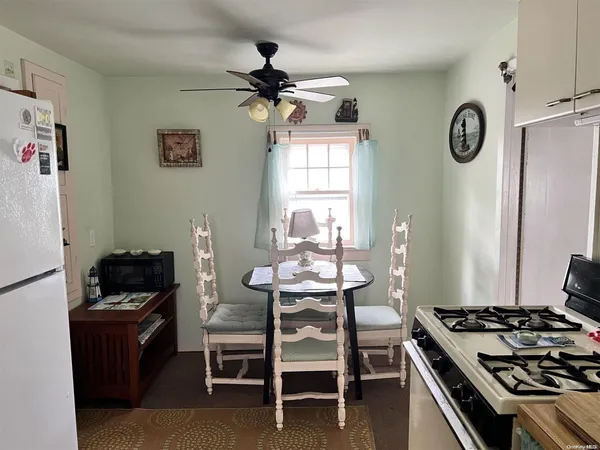 a kitchen with a table and chairs