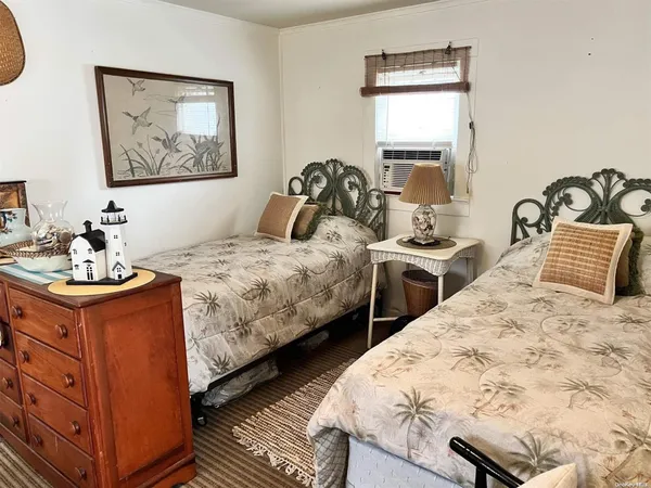 a bedroom with two beds and painting on the wall