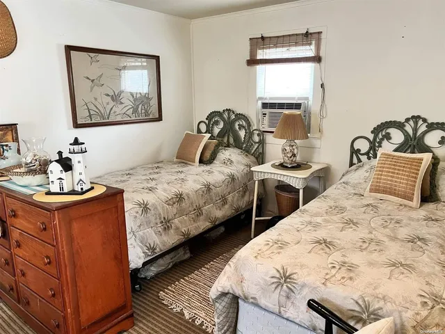 a bedroom with two beds and painting on the wall