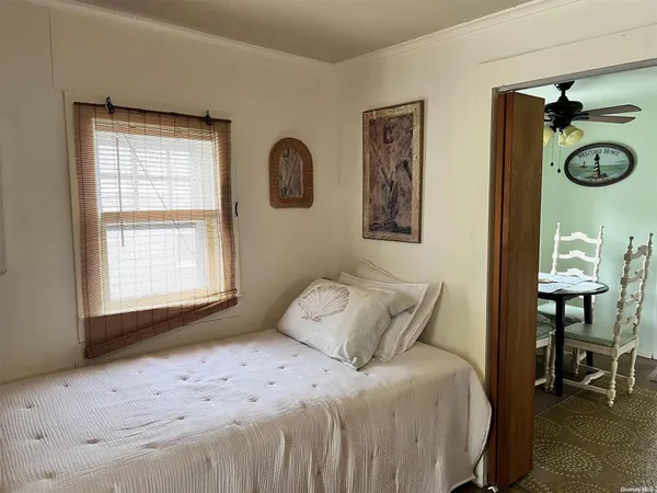 a bedroom with a bed and a window