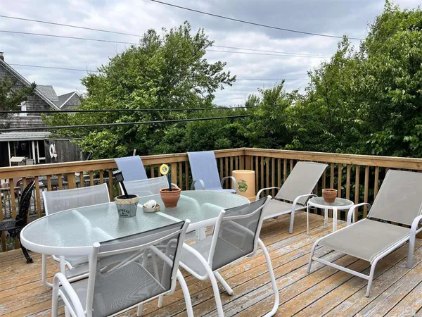 a balcony with table and chairs