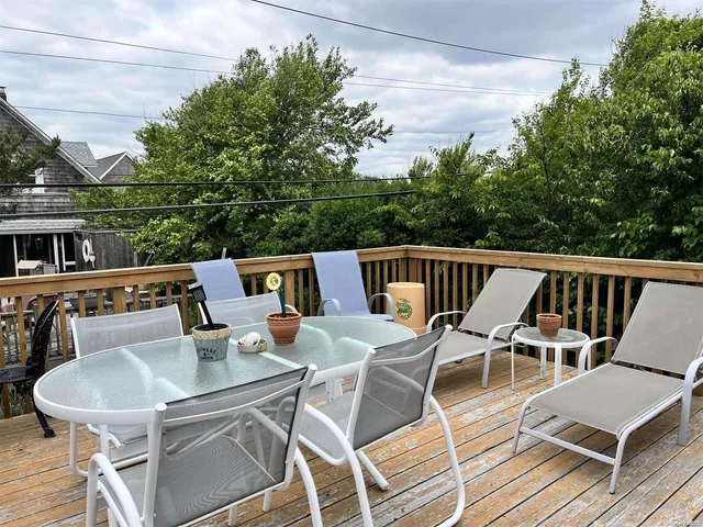 a balcony with table and chairs