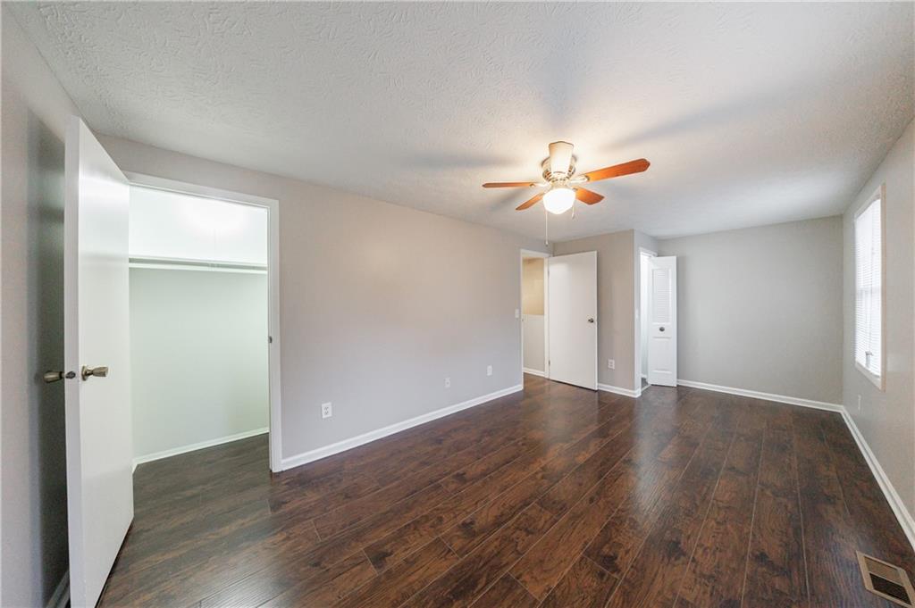 1960 Hamilton Place Southeast Marietta, GA 30067 - Photo 15 of 22 an empty room with wooden floor and ceiling fan