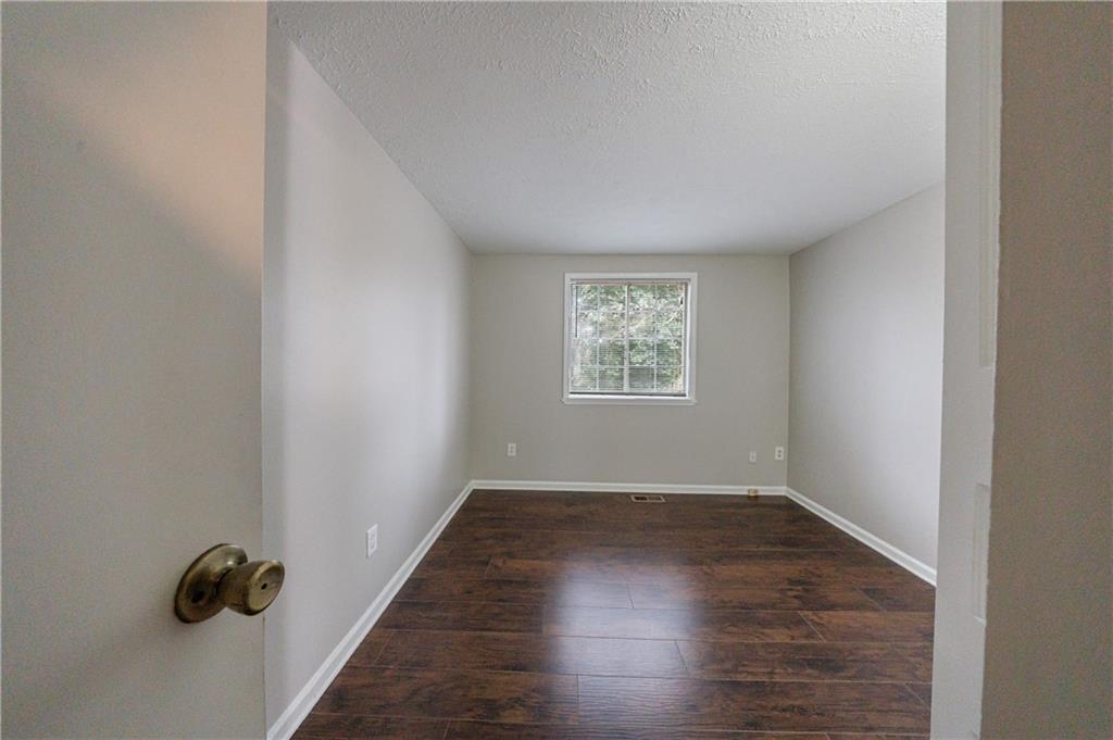 1960 Hamilton Place Southeast Marietta, GA 30067 - Photo 17 of 22 an empty room with wooden floor and windows