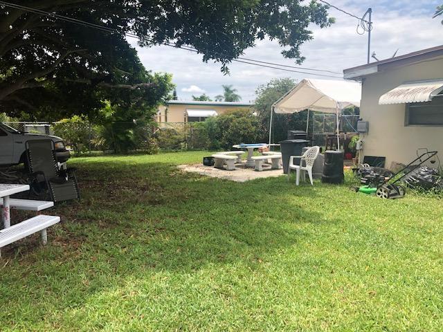 5544 South Rue Road West Palm Beach, FL 33415 - Photo 3 of 14 a view of a house with backyard sitting area and garden