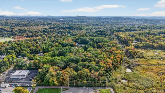 an aerial view of residential house with parking and yard