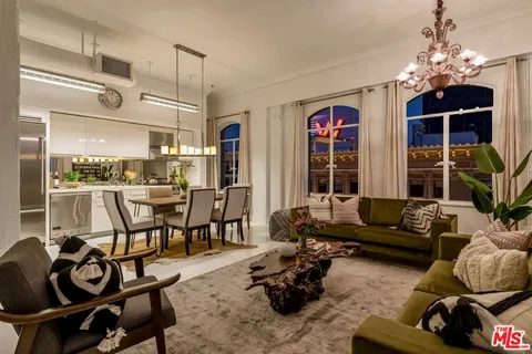 a living room with furniture and a chandelier