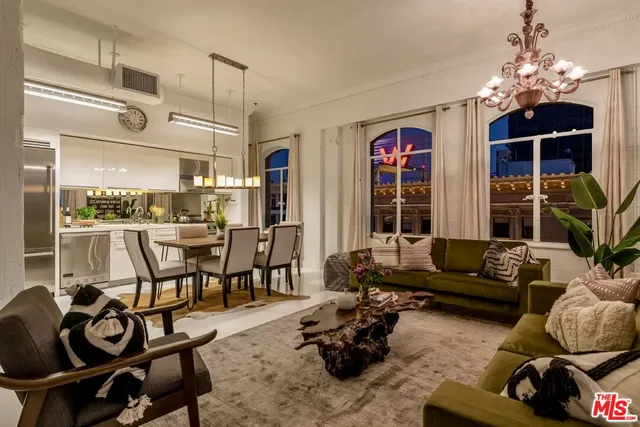a living room with furniture and a chandelier