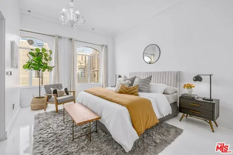 a bedroom with bed and a window