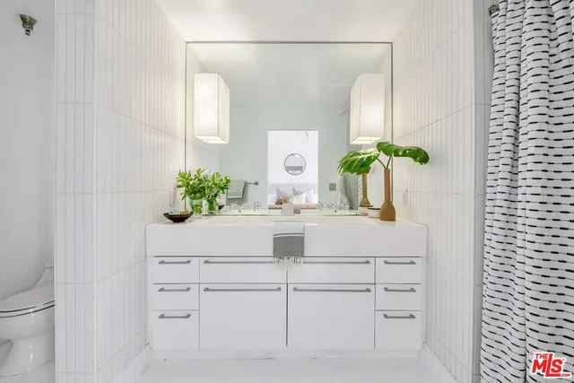 a bathroom with a sink a vanity and a mirror