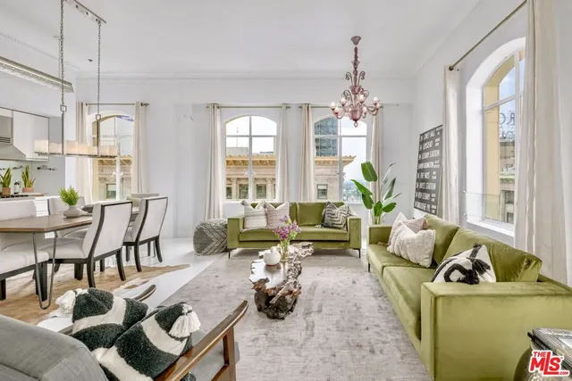 a living room with furniture and a chandelier