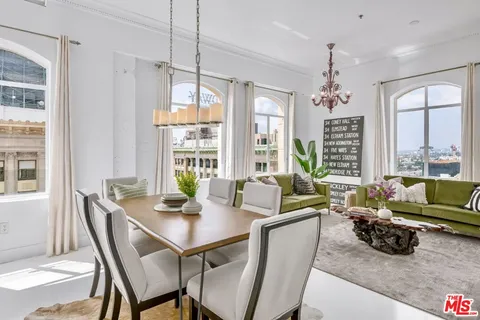 a view of a dining room with furniture large windows and wooden floor