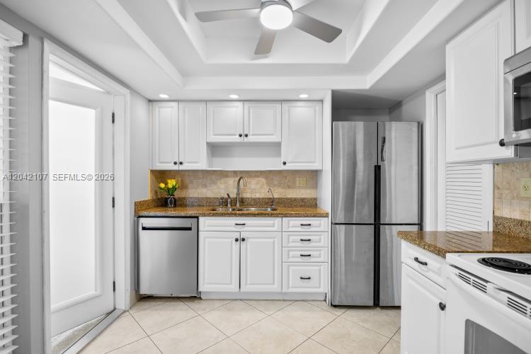 3213 Colony Club Road, Unit 3E Pompano Beach, FL 33062 - Photo 17 of 31 a kitchen with stainless steel appliances granite countertop a refrigerator sink and cabinets