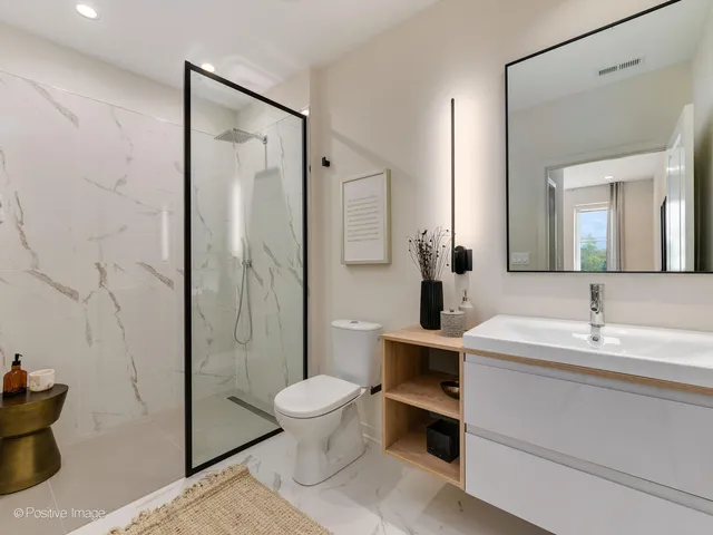 a bathroom with a toilet a sink and shower