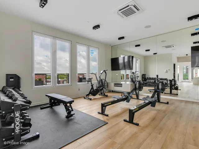 a living room with furniture hard wood floor and a table