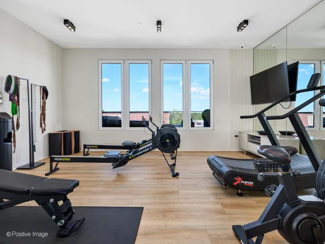 a living room with furniture flat screen tv and a large window
