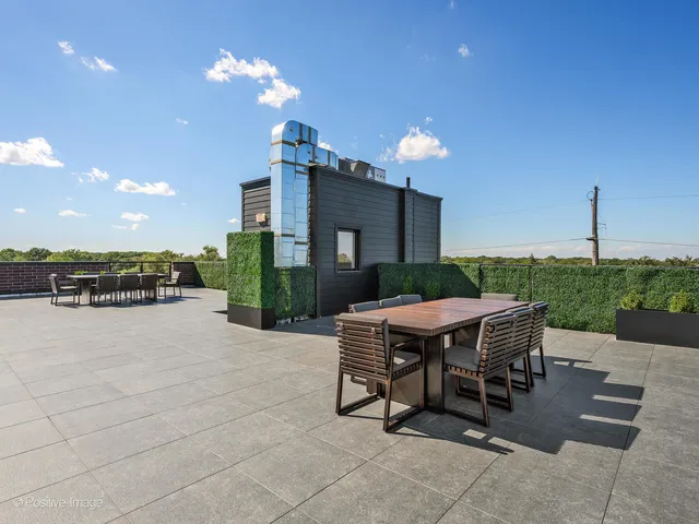 a view of a patio with a table and chairs