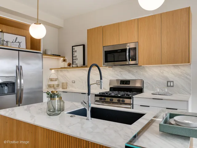 a kitchen with sink a stove and refrigerator