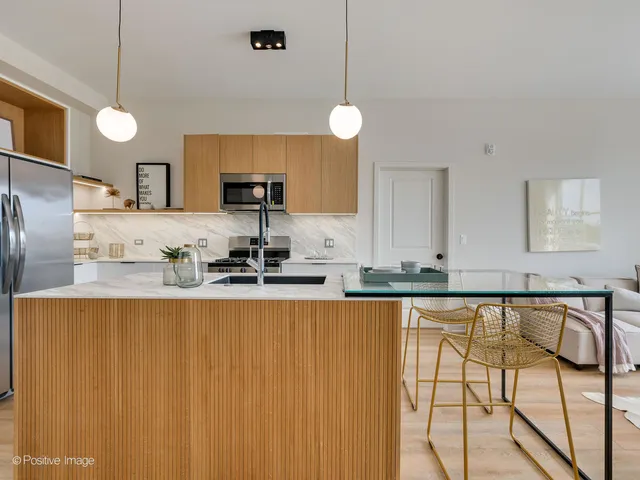 a large kitchen with lots of counter space and stainless steel appliances