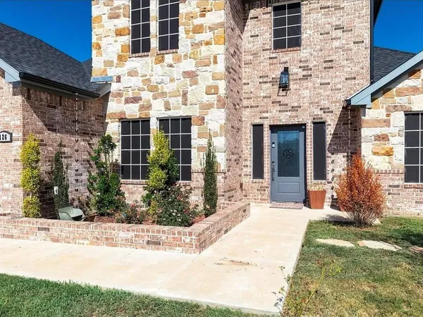 a view of a brick building next to a yard