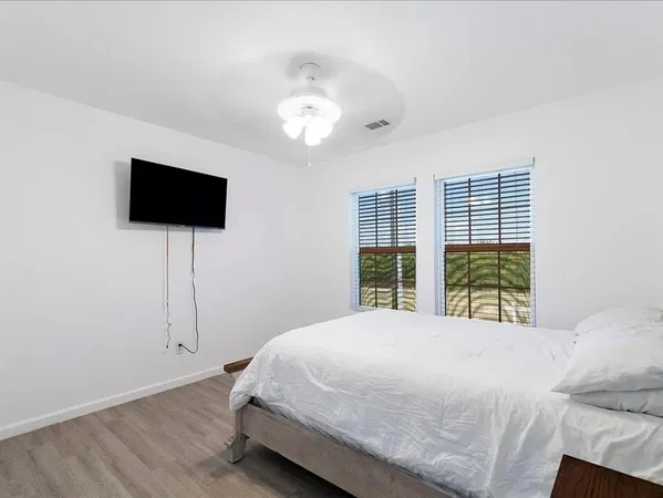 a bedroom with a bed and a flat screen tv