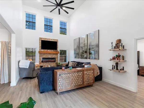a living room with fireplace furniture and a flat screen tv