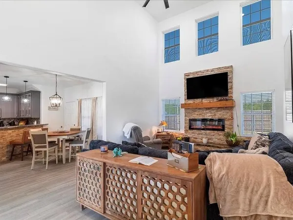 a living room with furniture a fireplace and a flat screen tv