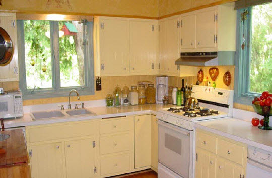 6066 Cunningham Road Rockford, IL 61102 - Photo 4 of 6 a kitchen with stainless steel appliances a sink a stove and white cabinets next to a window