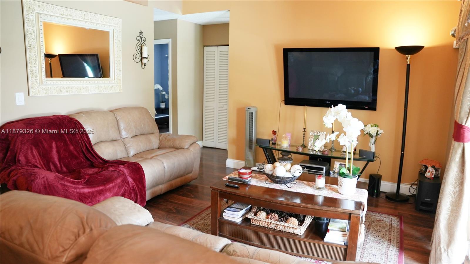 14856 Southwest 174th Street Miami, FL 33187 - Photo 19 of 31 a living room with furniture and a flat screen tv