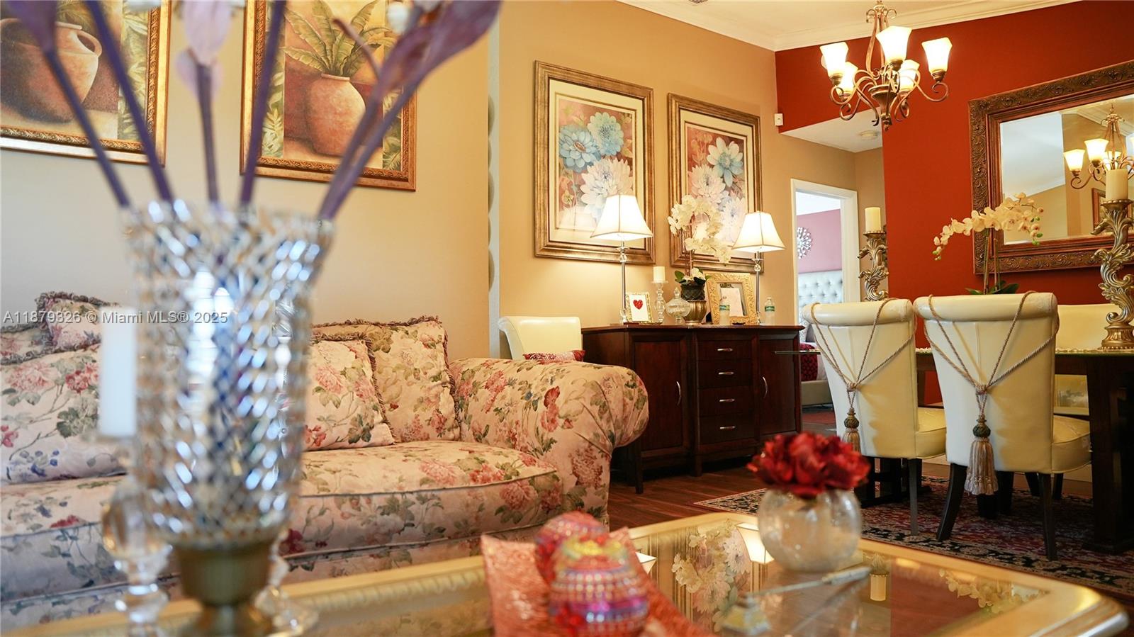 14856 Southwest 174th Street Miami, FL 33187 - Photo 2 of 31 a living room with furniture and a chandelier