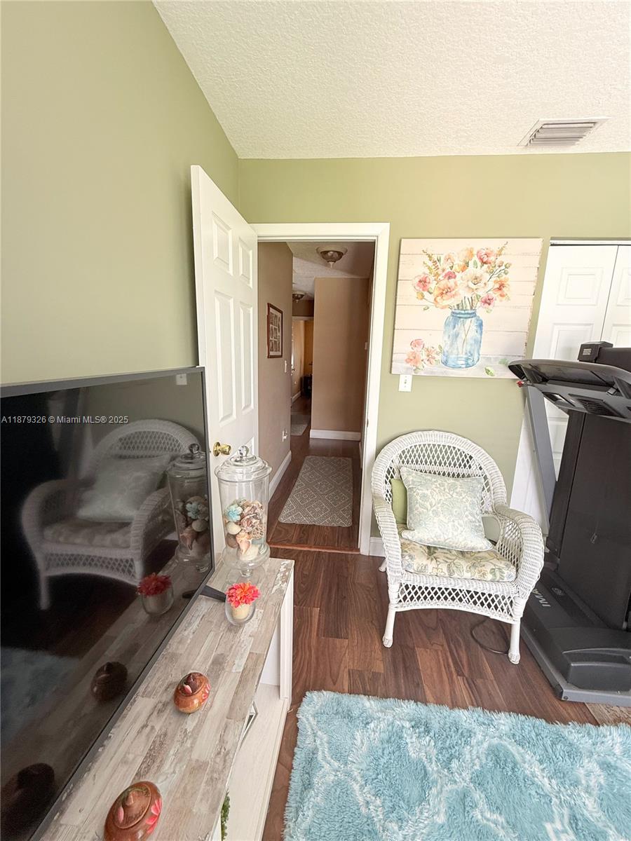 14856 Southwest 174th Street Miami, FL 33187 - Photo 22 of 31 a living room with a couch chair and a fireplace