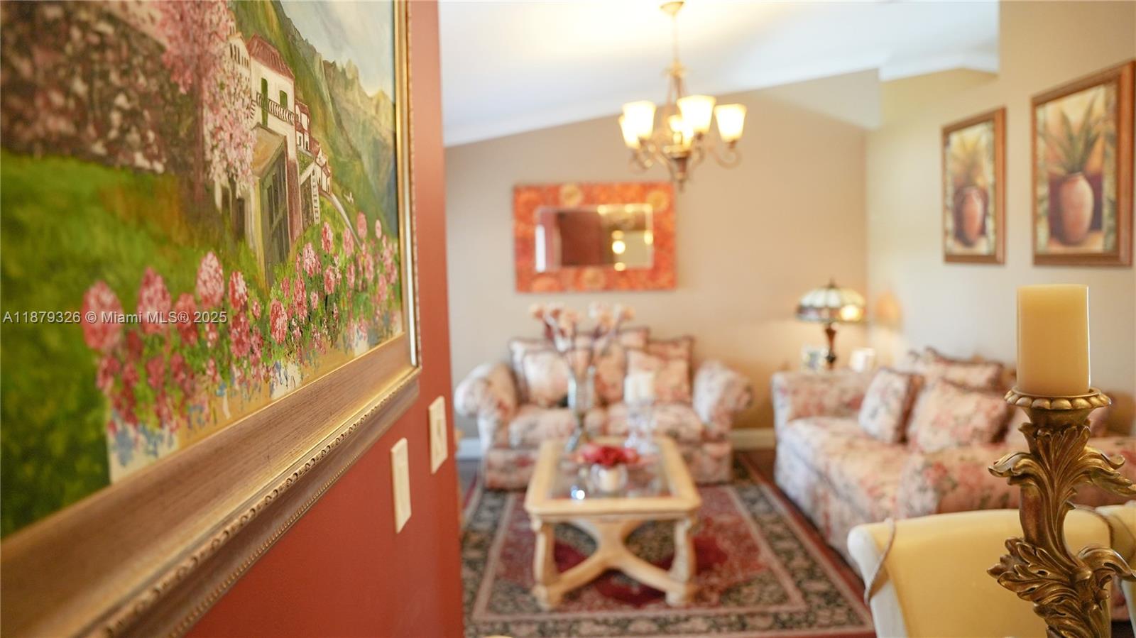 14856 Southwest 174th Street Miami, FL 33187 - Photo 4 of 31 a living room with furniture and a chandelier