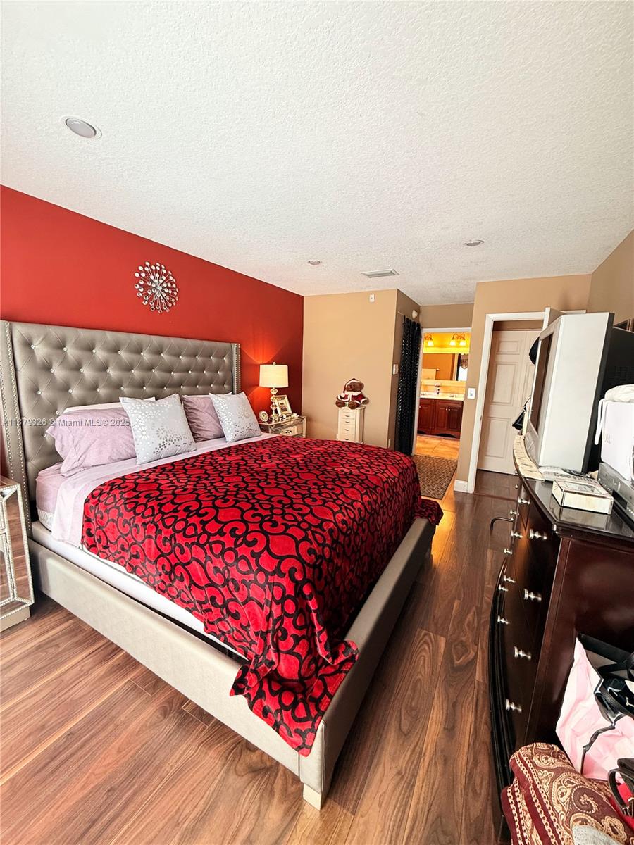 14856 Southwest 174th Street Miami, FL 33187 - Photo 7 of 31 a bedroom with a bed and wooden floor