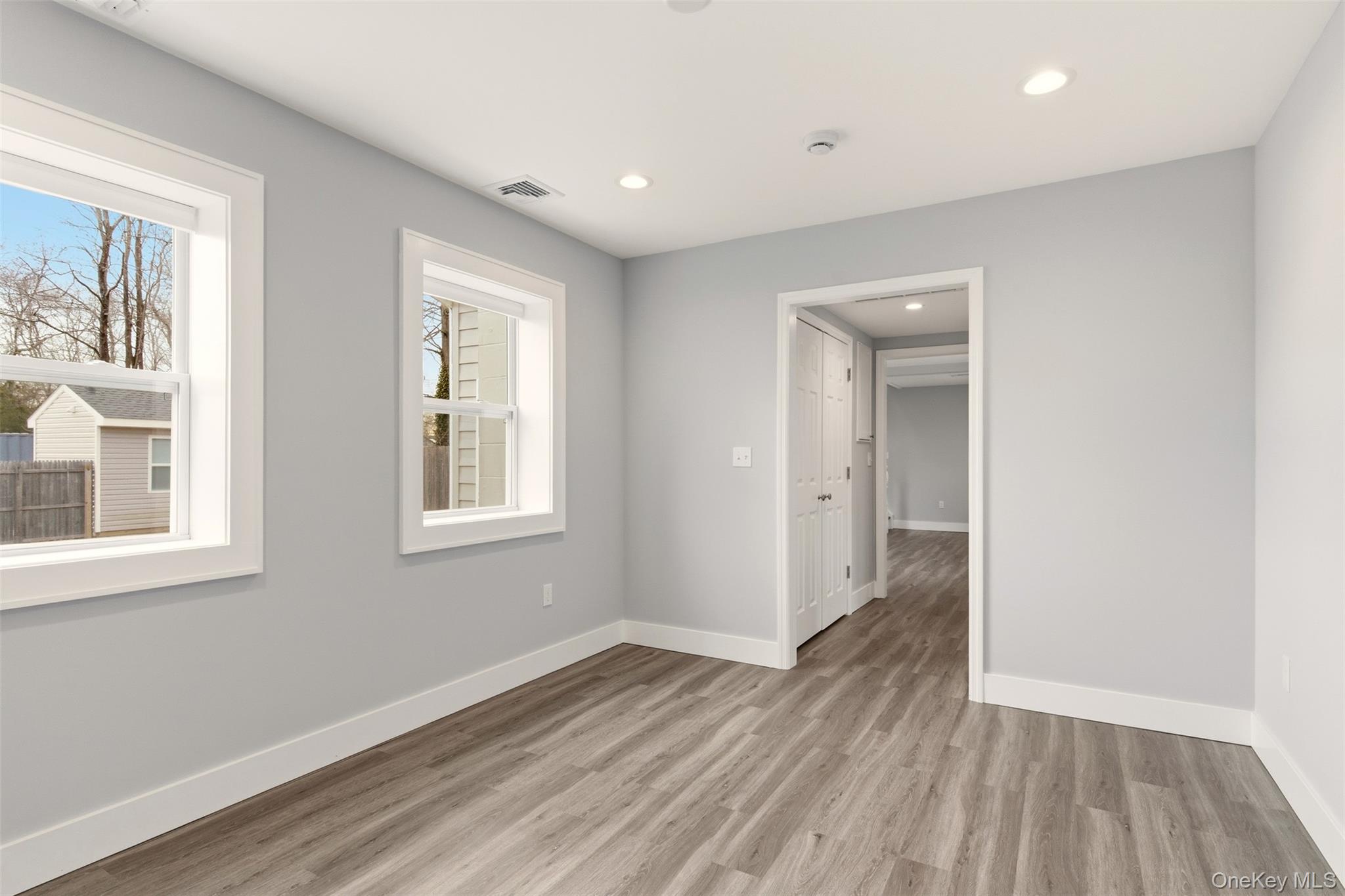 60 Frowein Road Center Moriches, NY 11934 - Photo 12 of 41 a view of an empty room with wooden floor and a window