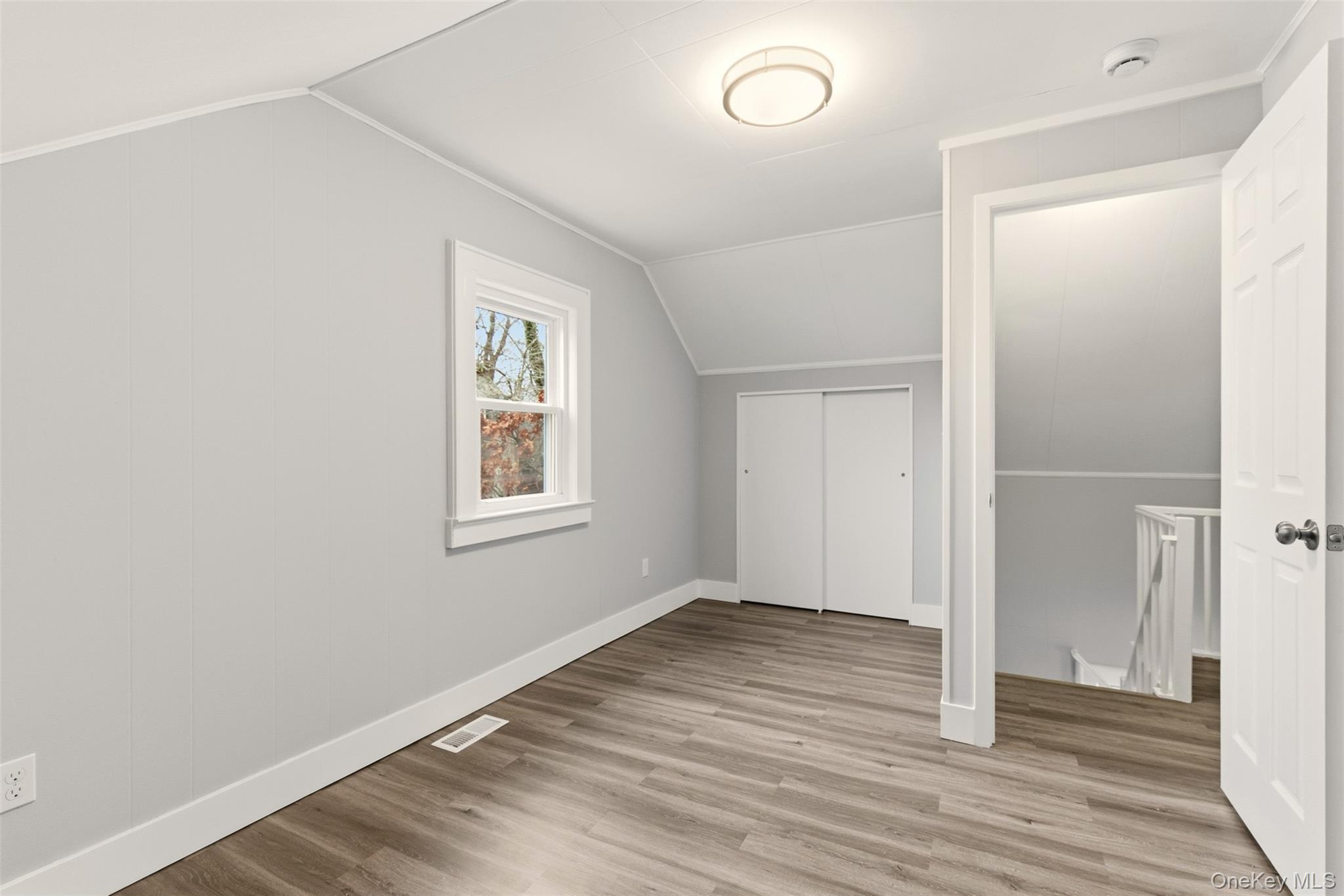 60 Frowein Road Center Moriches, NY 11934 - Photo 17 of 41 an empty room with wooden floor and windows