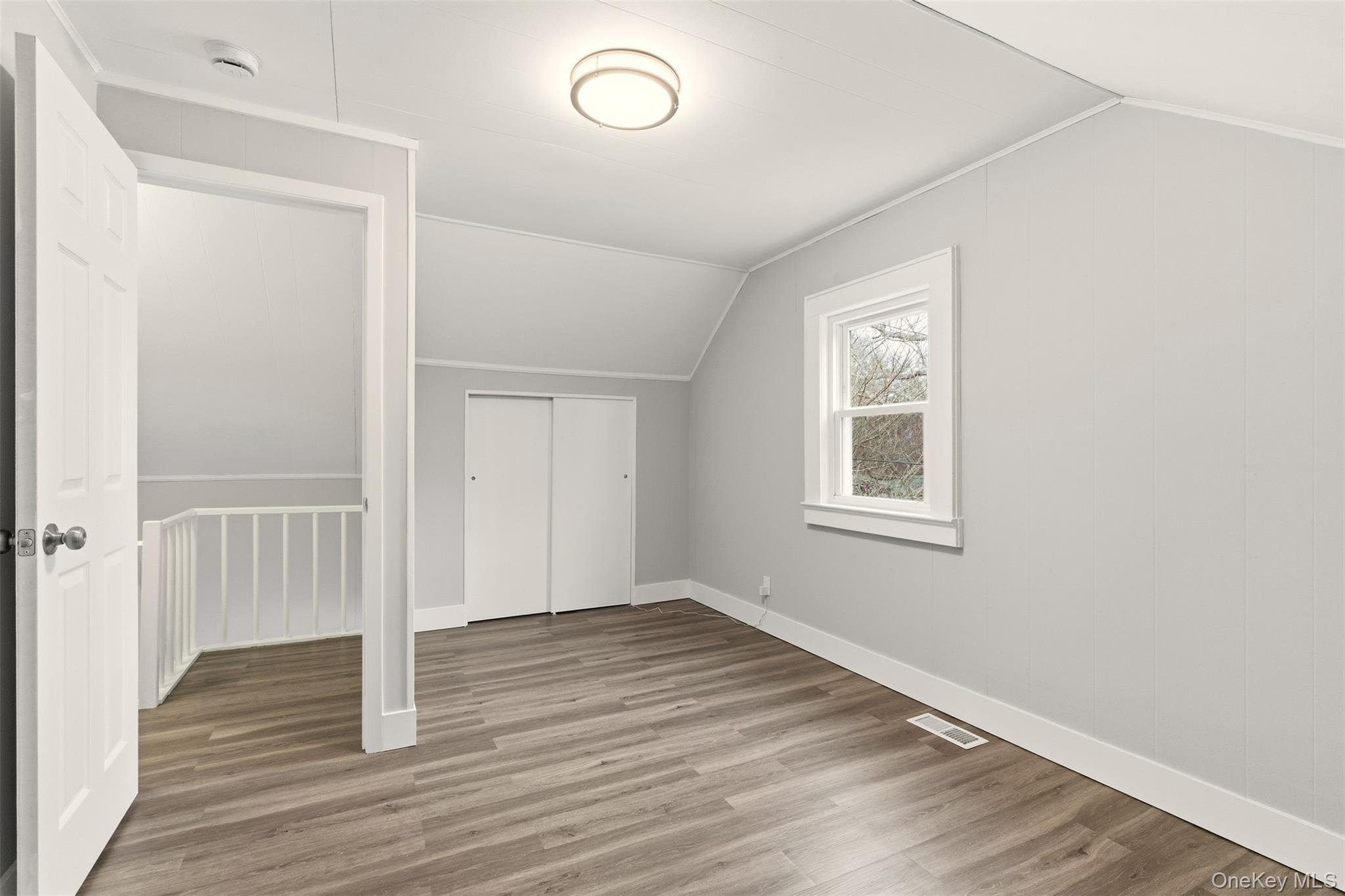 60 Frowein Road Center Moriches, NY 11934 - Photo 18 of 41 an empty room with wooden floor and windows