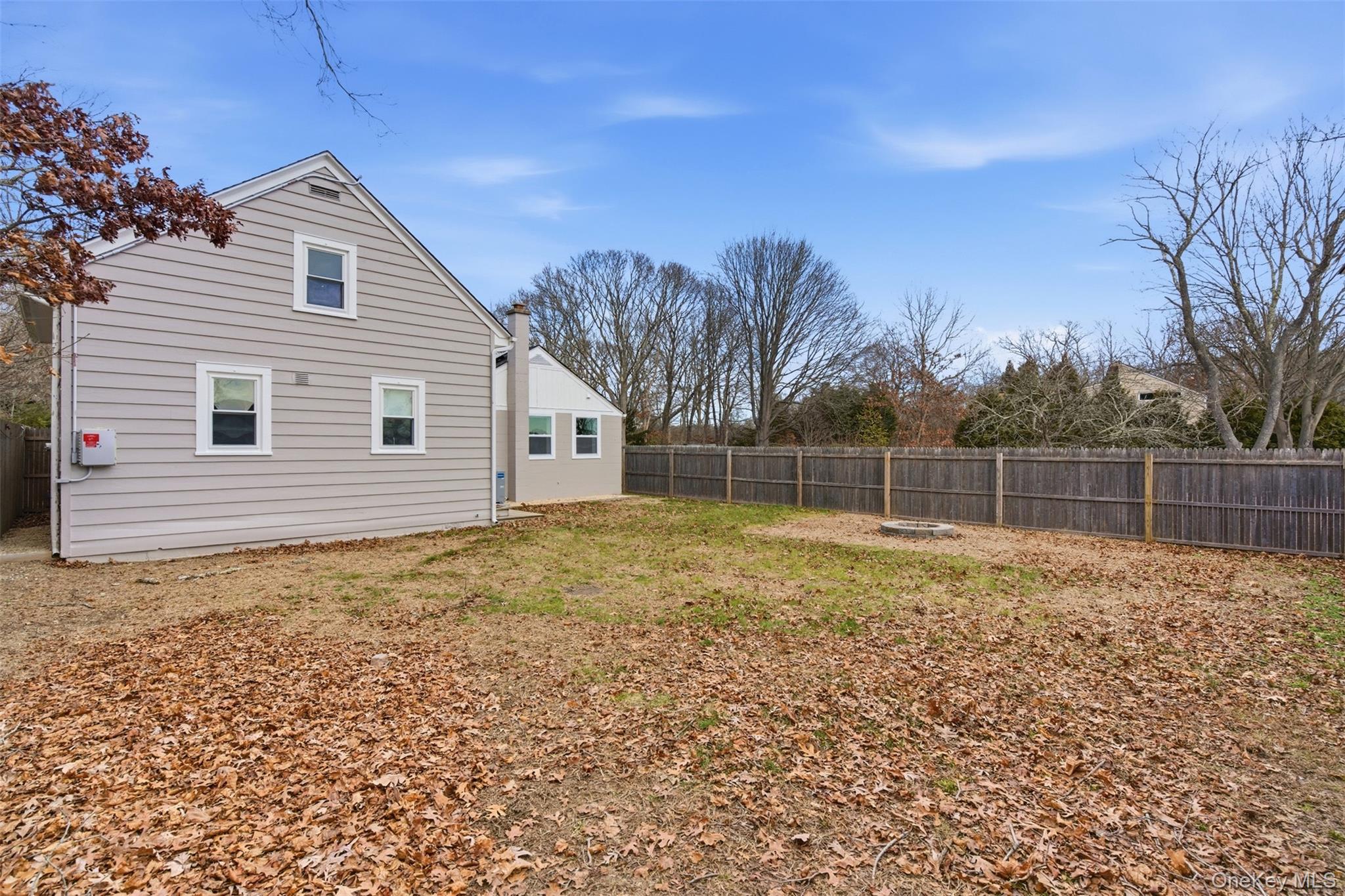 60 Frowein Road Center Moriches, NY 11934 - Photo 22 of 41 a backyard of a house with plants and large trees