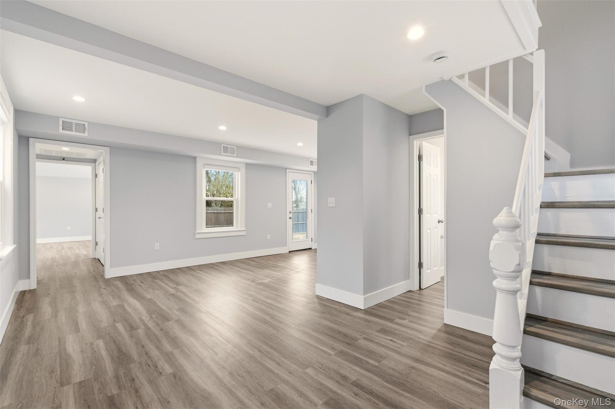 60 Frowein Road Center Moriches, NY 11934 - Photo 4 of 41 wooden floor in an empty room with a window