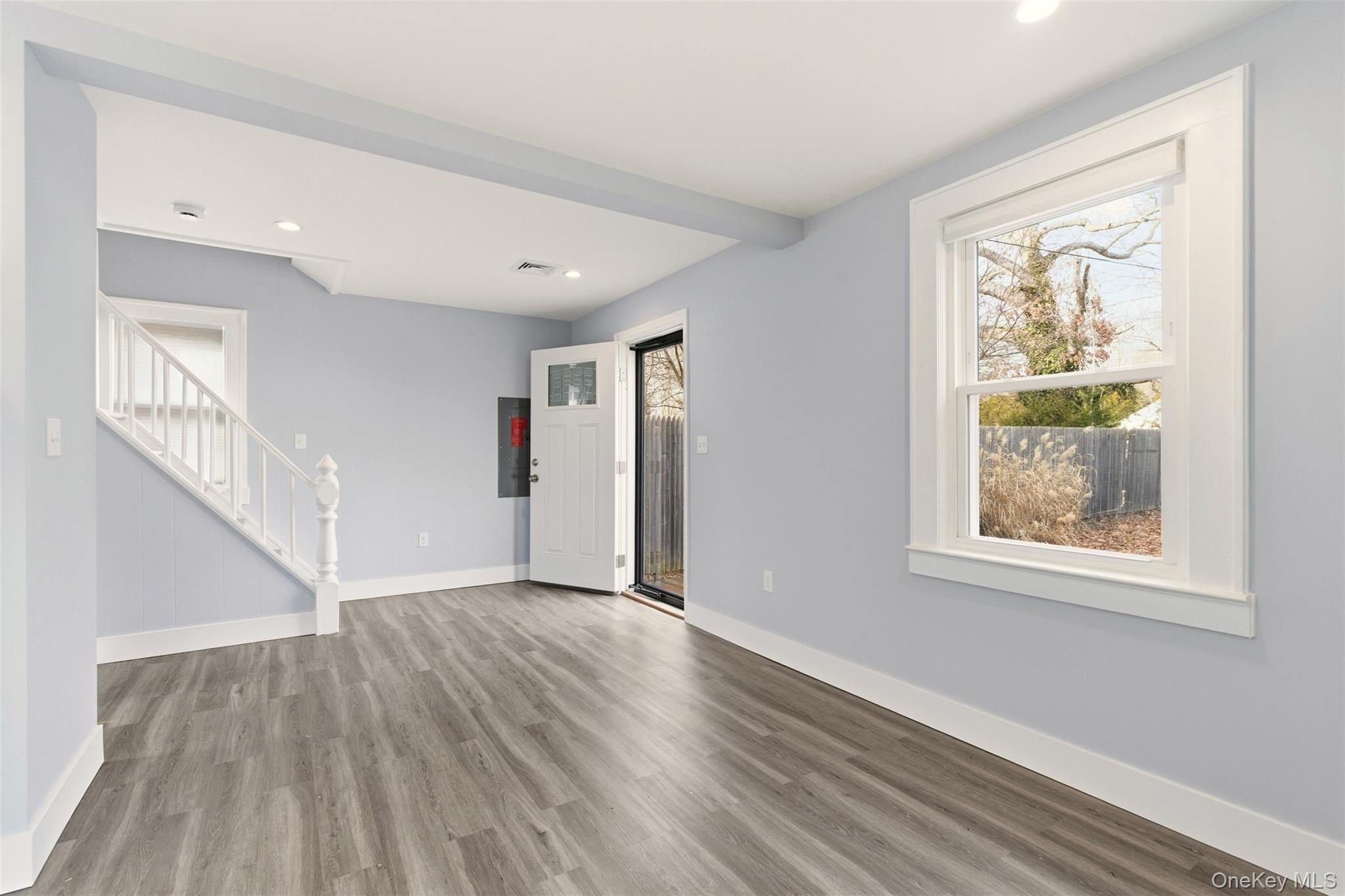 60 Frowein Road Center Moriches, NY 11934 - Photo 5 of 41 a view of an empty room with wooden floor and a window