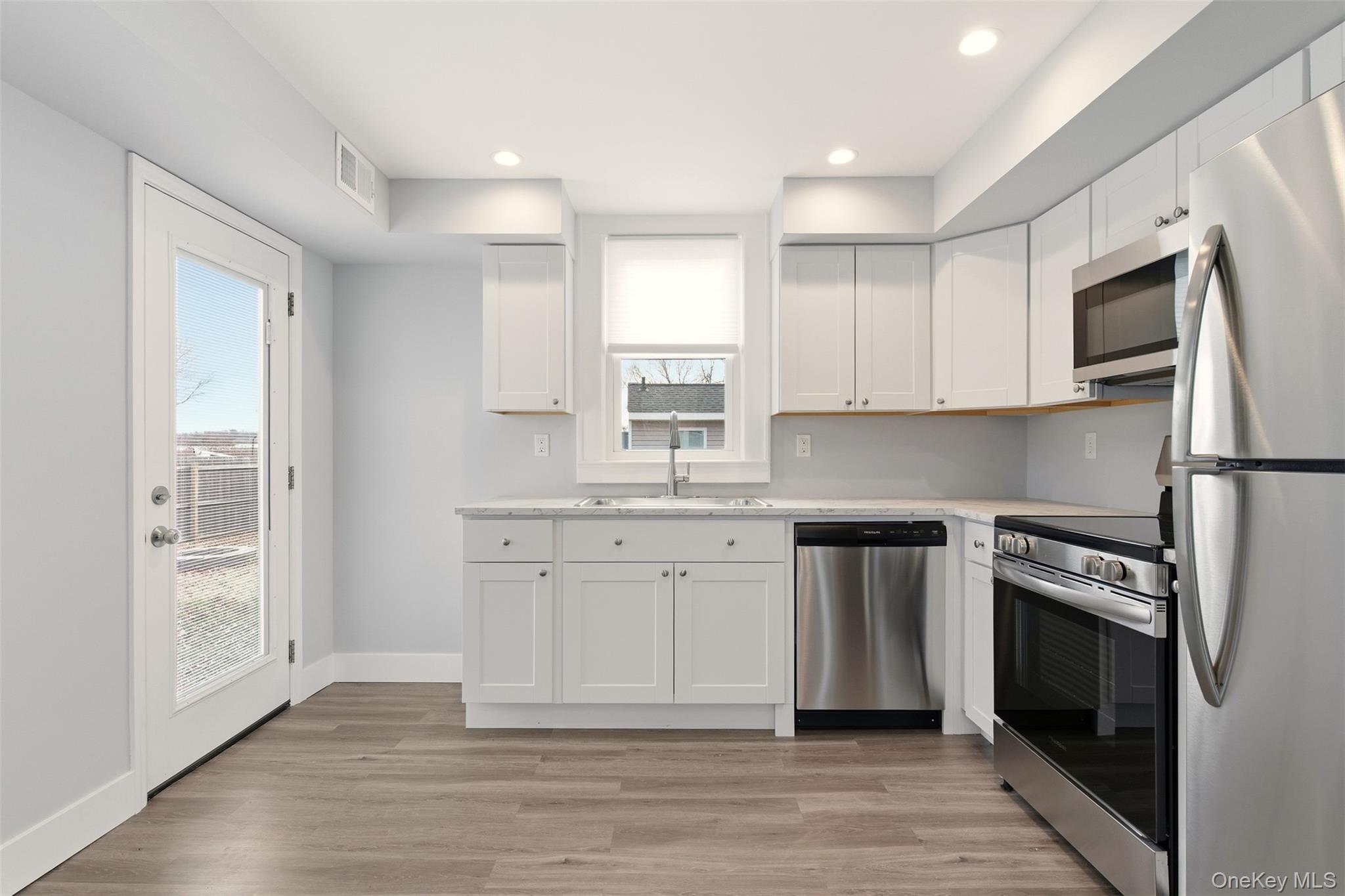60 Frowein Road Center Moriches, NY 11934 - Photo 8 of 41 a kitchen with stainless steel appliances granite countertop a stove a sink and a refrigerator