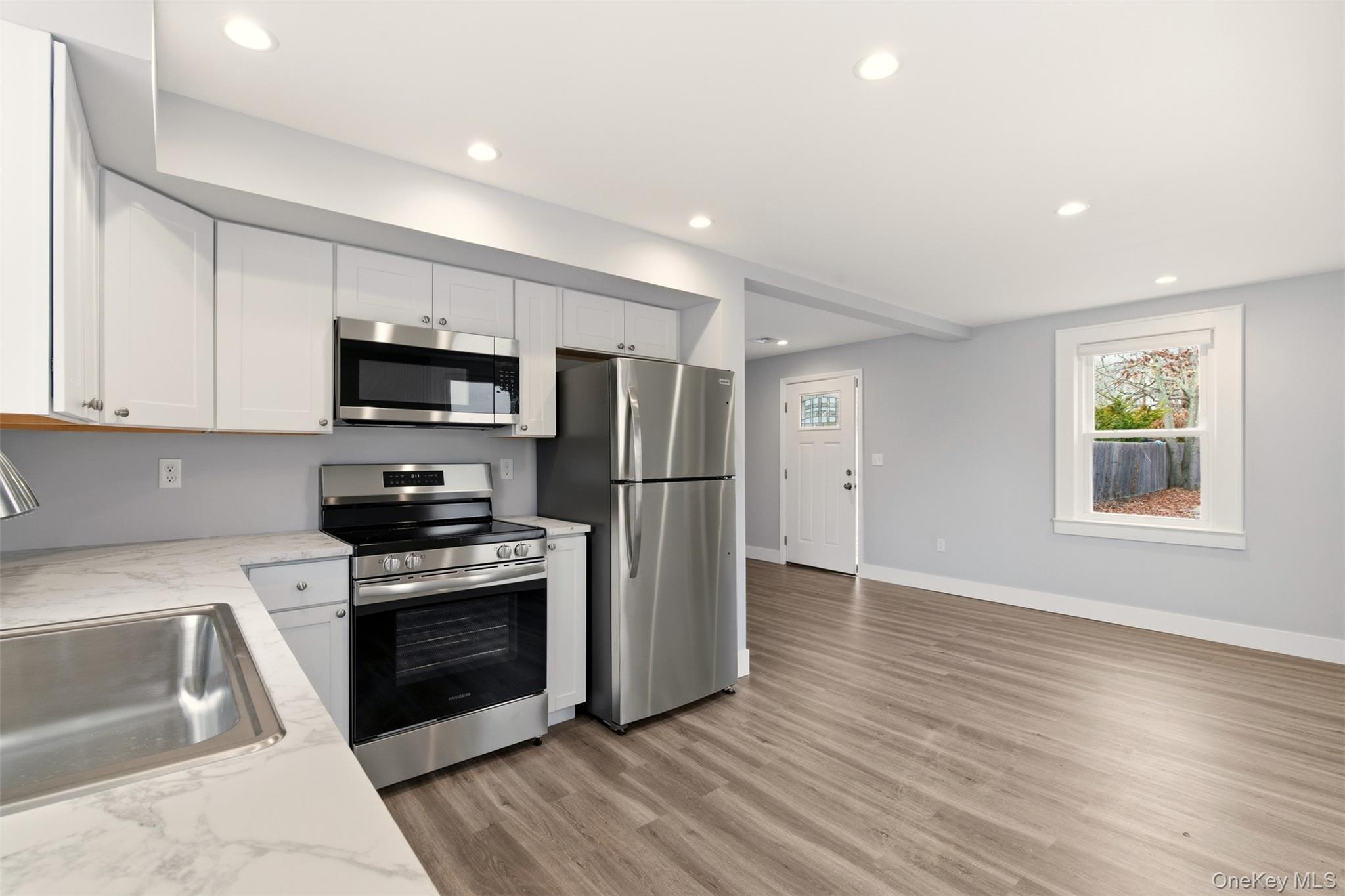 60 Frowein Road Center Moriches, NY 11934 - Photo 9 of 41 a kitchen with stainless steel appliances granite countertop a stove a sink and a refrigerator
