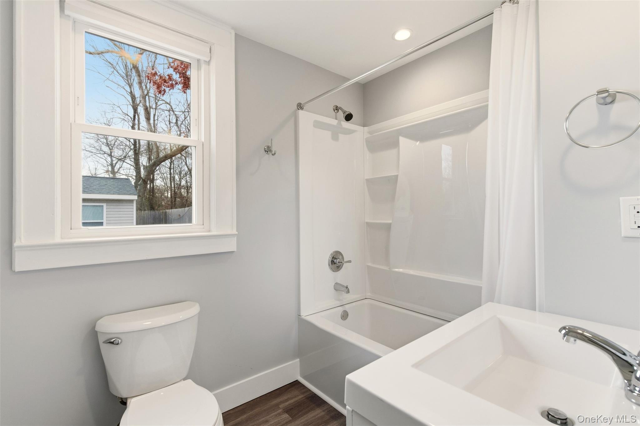 60 Frowein Road Center Moriches, NY 11934 - Photo 10 of 41 a bathroom with a sink a mirror a toilet and a shower