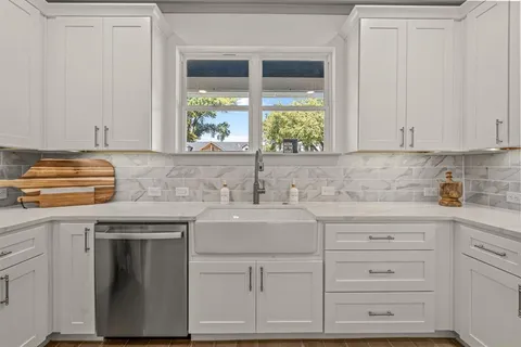 a kitchen with granite countertop a sink and a window